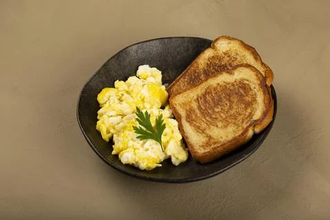 Breakfast. Scrambled egg with toast. Stock Photos