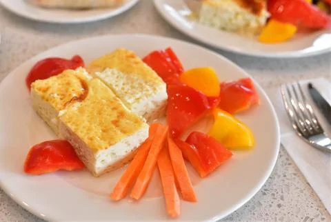 Breakfast - scrambled eggs and fresh carrots and bell peppers Stock Photos
