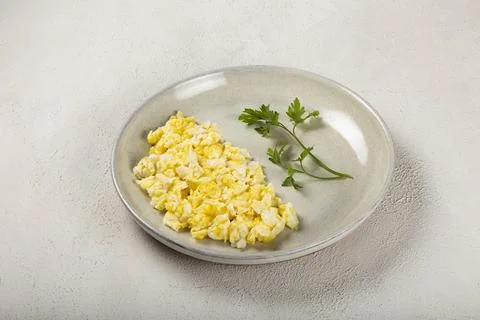 Breakfast with scrambled eggs on the table. Stock Photos