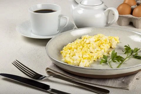 Breakfast with scrambled eggs on the table. Stock Photos