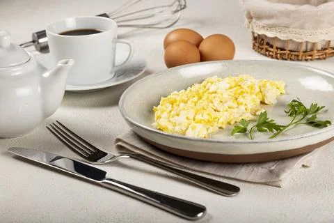 Breakfast with scrambled eggs on the table. Stock Photos
