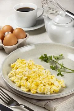 Breakfast with scrambled eggs on the table. Stock Photos