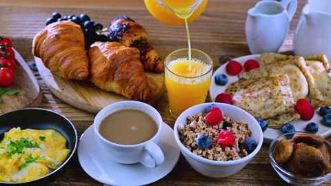 Breakfast served with coffee, orange juice, cereals, pancakes and croissants Stock Footage 266414705