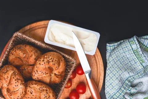 Breakfast served. Cooked buns with cherry tomatoes and melted cheese on the t Stock Photos