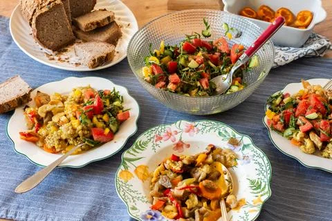 Breakfast is served on a dining table with green buckwheat, chicken breast,.. Stock Photos