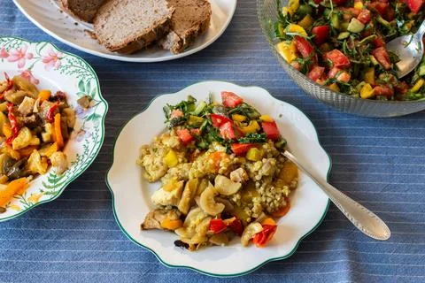 Breakfast is served on a dining table with green buckwheat, chicken breast, r Stock Photos