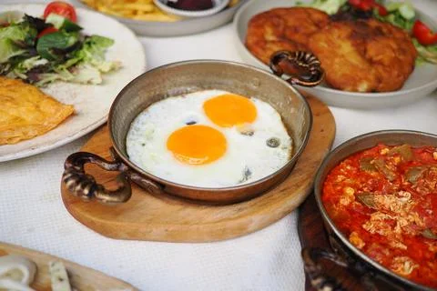 Breakfast served with eggs and other dishes on the table Stock Photos