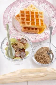 Breakfast on a serving tray with grape, waffle and milled flaxseed Stock Photos