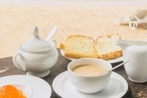 Breakfast set on the beach Stock Photos