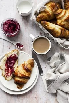Breakfast set flat lay with croissant and raspberry jam Stock Photos