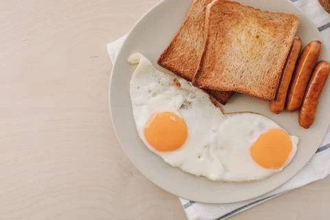 Breakfast set of fried eggs toasted bread sausages and tuna spread. Stock-Fotos