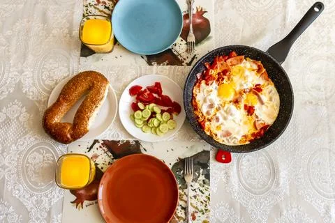 Breakfast set with scrambled eggs, fresh vegetables, fresh bread and orange j Stock Photos