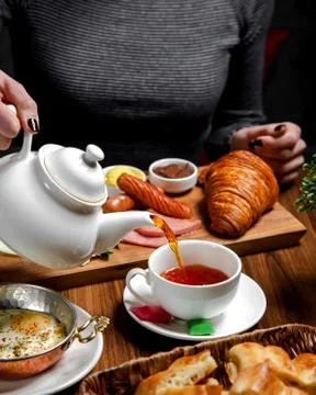 Breakfast set on the table with black tea Stock Photos