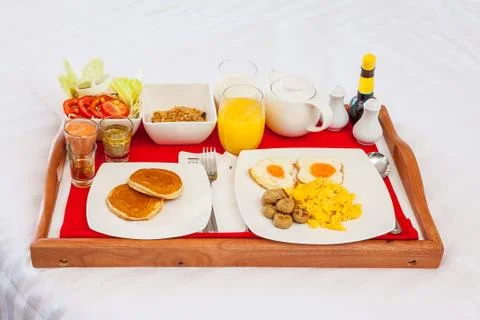 Breakfast set in tray on bed Foto stock