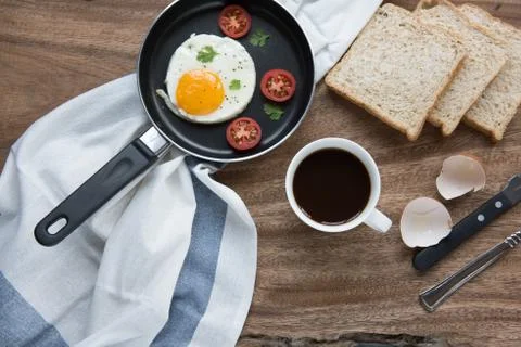 Breakfast setting with black coffee and sauaage bacon omelette on the table w Stock Photos