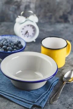 Breakfast setting with empty metal bowl Stock Photos