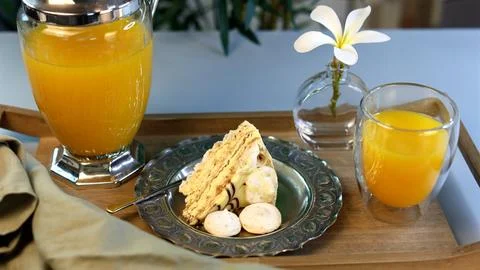 Breakfast setup emphasizes bold contrasts using textured silver plate, golden Stock Photos