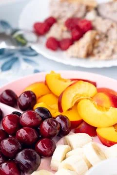 Breakfast setup with hot beverage, sliced fruit, and oatmeal served on patt.. Stock Photos