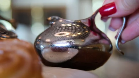 Breakfast setup includes polished silver teapot with ornate detailing, curved Stock Footage 315315254