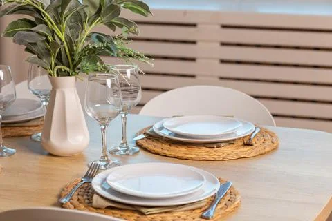 Breakfast setup on wooden table with nice vase and modern chair. Фото