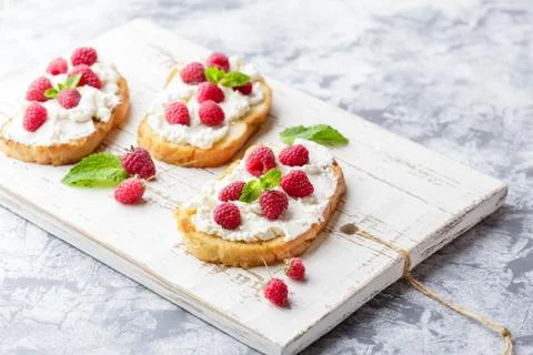 Breakfast slice of bread with Ricotta cheese served with raspberries Stock Photos