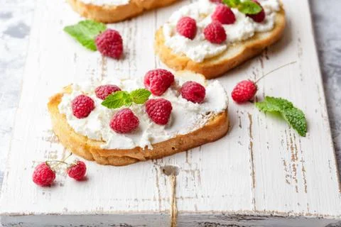 Breakfast slice of bread with Ricotta cheese served with raspberries Stock Photos