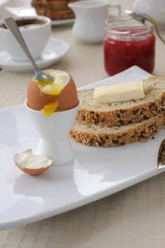 Breakfast with soft-boiled egg and slices of oatmeal bread Soft-boiled egg... Stock Photos