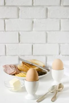 Breakfast with soft-boiled egg, bread toast, ham, cheese and canned cucumbers Stock Photos