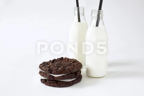 Breakfast of some cookies and two bottles of milk Stock Photos