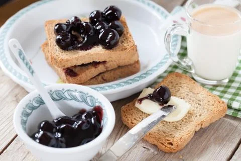 Breakfast With Sour Cherry Jam Milk And Rusks Stock Photos