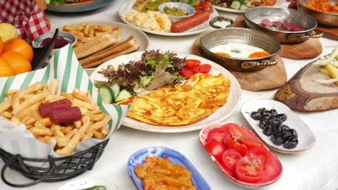Breakfast spread with eggs, vegetables, and various dishes Stock Footage 339755451