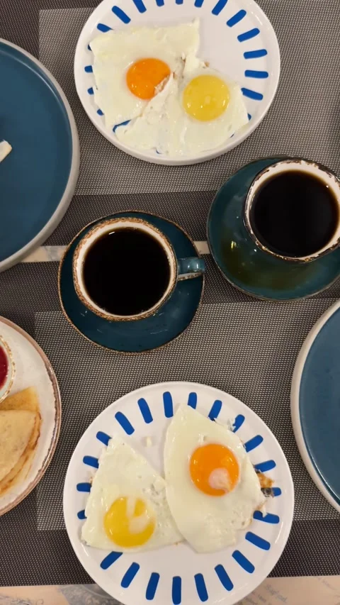 Breakfast spread with fried eggs, coffee, bread, sausages, pancakes, and sa.. Stock Footage 323715411