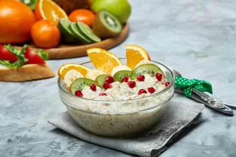 Breakfast still life with oatmeal porridge and fruits, top view, selective focus Stock Photos