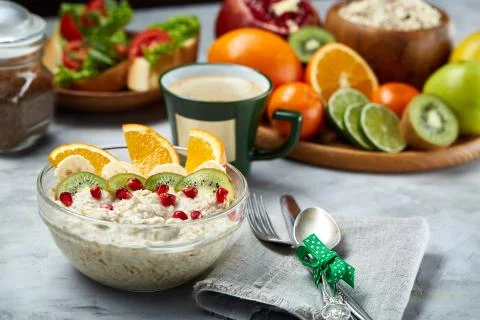Breakfast still life with oatmeal porridge, fruits and coffee cup, top view Stock Photos