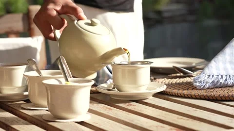 Breakfast table and tea pot pouring tea in a cup in Kathmandu, Nepal. Stock Footage 169919058