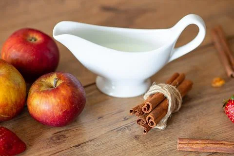 Breakfast table with apples, milk, and cinnamon Stock Photos