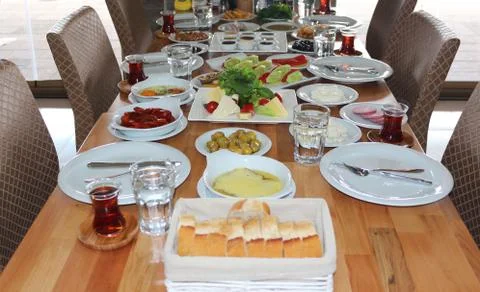 Breakfast Table with Bread, Black Tea, Cheese and Salad Stock Photos