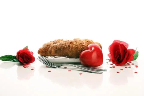 Breakfast on table with bread buns, croissants, coffe and juice on valentines Foto stock