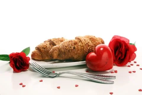 Breakfast on table with bread buns, croissants, coffe and juice on valentines Stock Photos