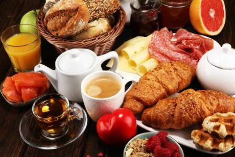 Breakfast on table with bread buns, croissants, coffe and juice on valentines Stock Photos
