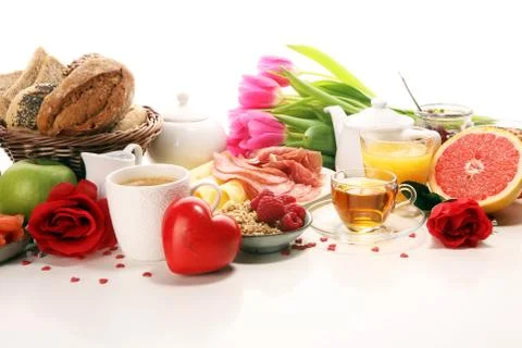 Breakfast on table with bread buns, croissants, coffe and juice on valentines Stock Photos