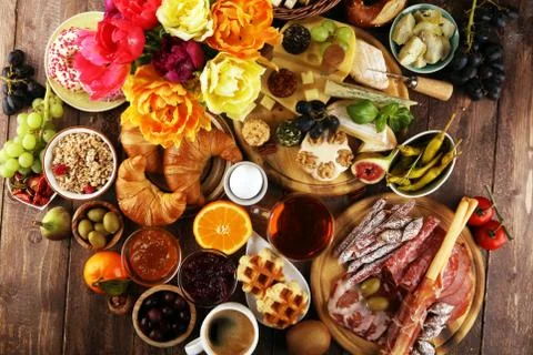 Breakfast on table with bread buns, croissants, coffe and cheese Stock Photos
