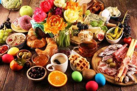 Breakfast on table with bread buns, croissants, coffe and cheese Stock Photos