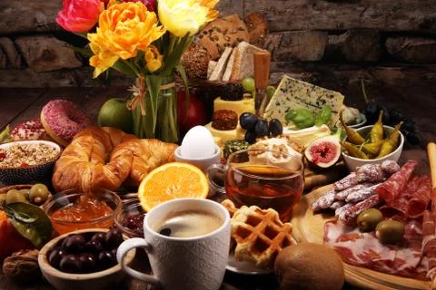Breakfast on table with bread buns, croissants, coffe and cheese Stock Photos