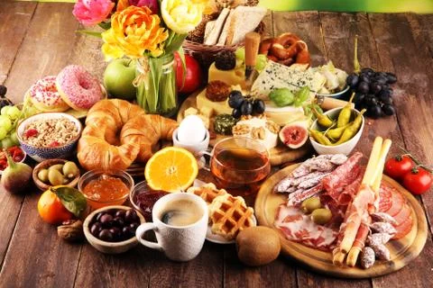 Breakfast on table with bread buns, croissants, coffe and cheese Stock Photos
