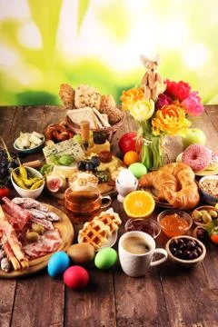 Breakfast on table with bread buns, croissants, coffe and cheese Stock Photos
