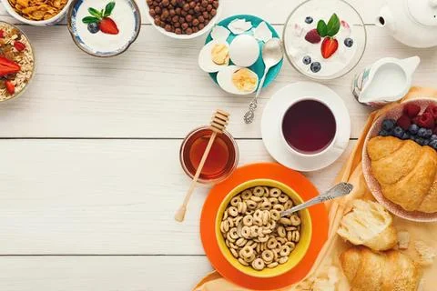 Breakfast table with cereal bread fruit and drinks Stock Photos
