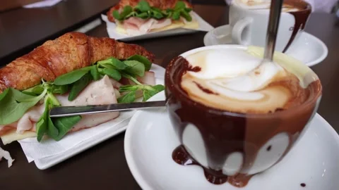 Breakfast table - chocolate coffee and croissant with ham Stock Footage 224315740