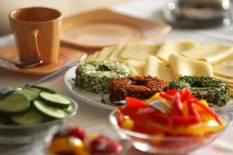 Breakfast Table Closeup cheese plate vegetables 2 Stock Photos