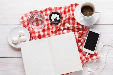 Breakfast table with coffee, eggs, and smartphone on white Stock Photos